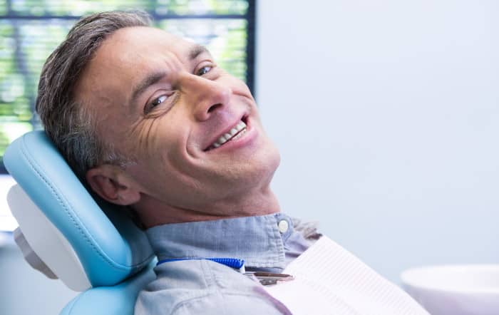 man smiling dental chair