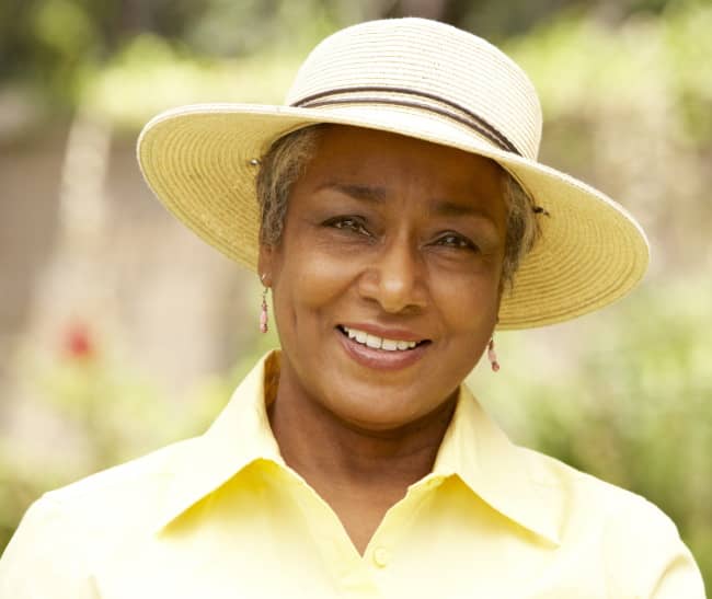older woman with hat smiling