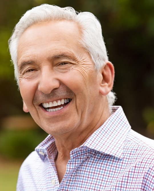 man smiling with dental implants